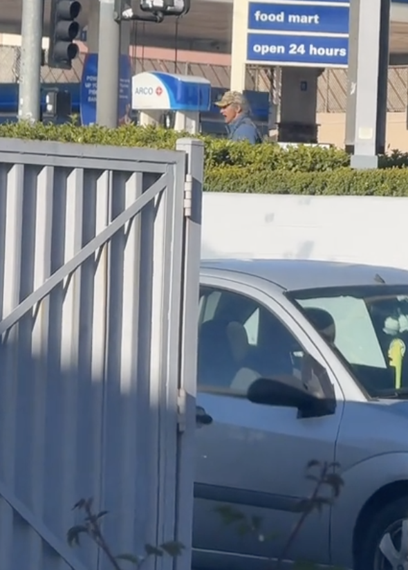 man panhandling outside gas station